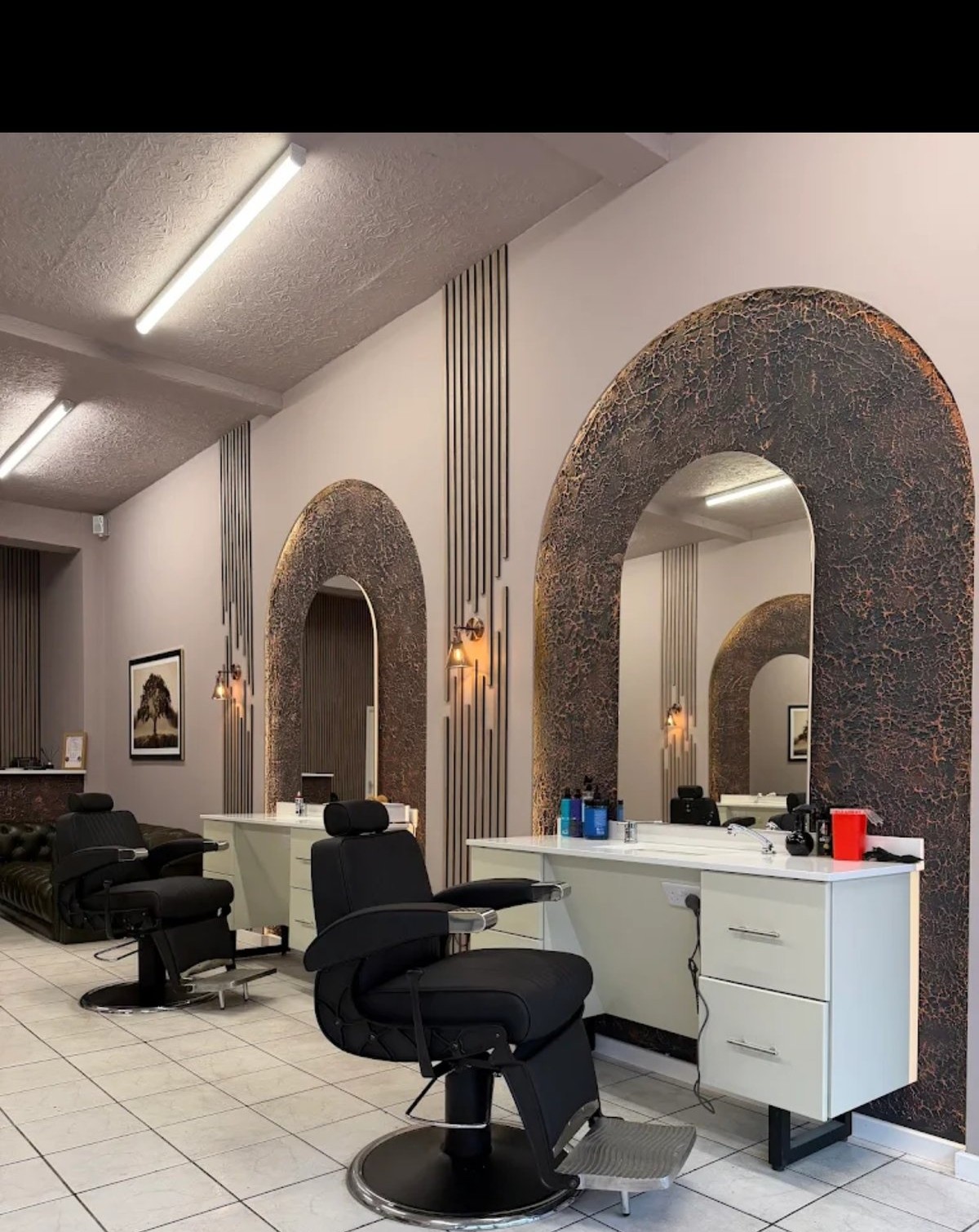 The House of Barberium interior — arch mirrors and barber chairs